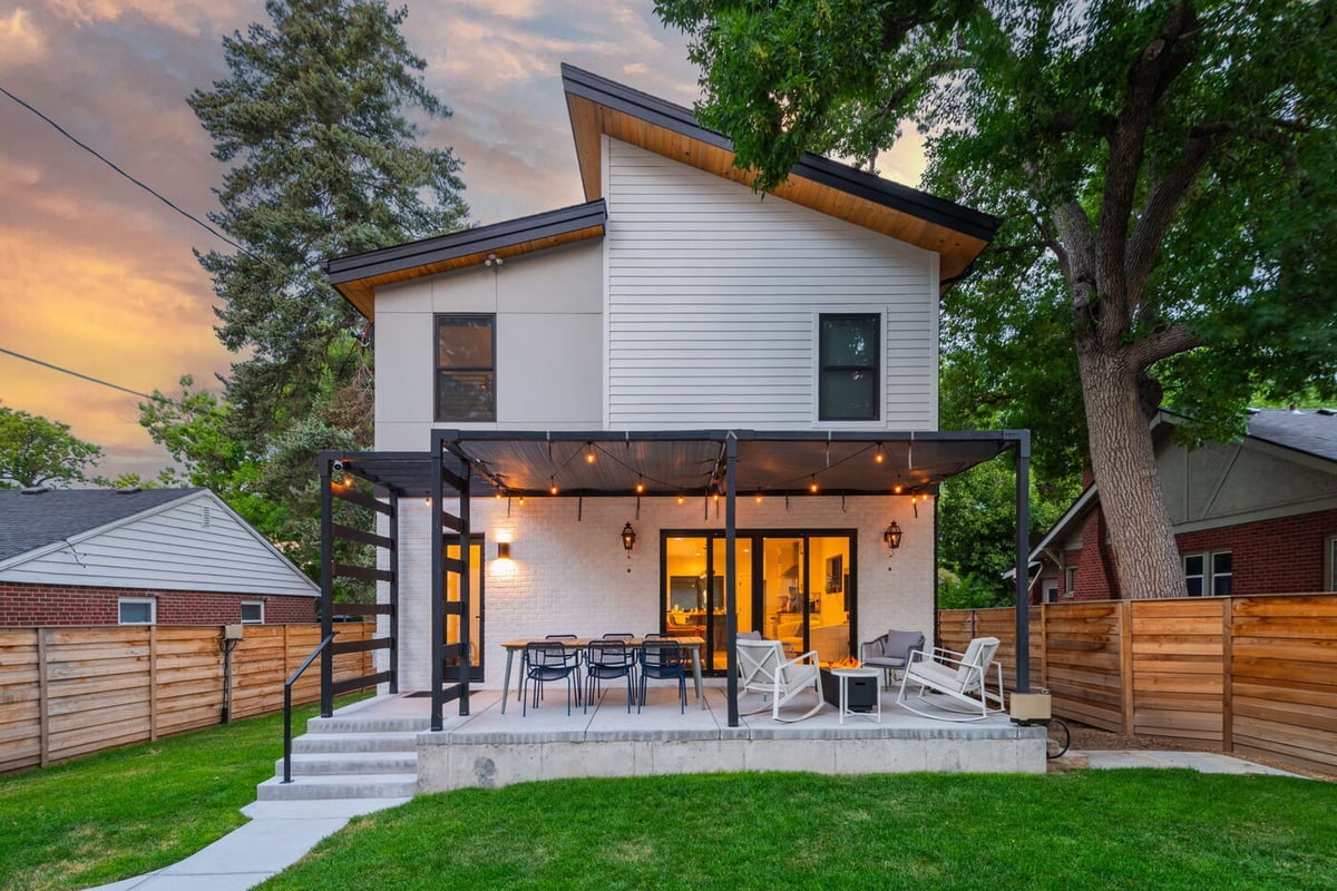 Denver pop top renovation backyard with covered patio, outdoor dining, seating, and string lights in Denver by Cillessen Construction