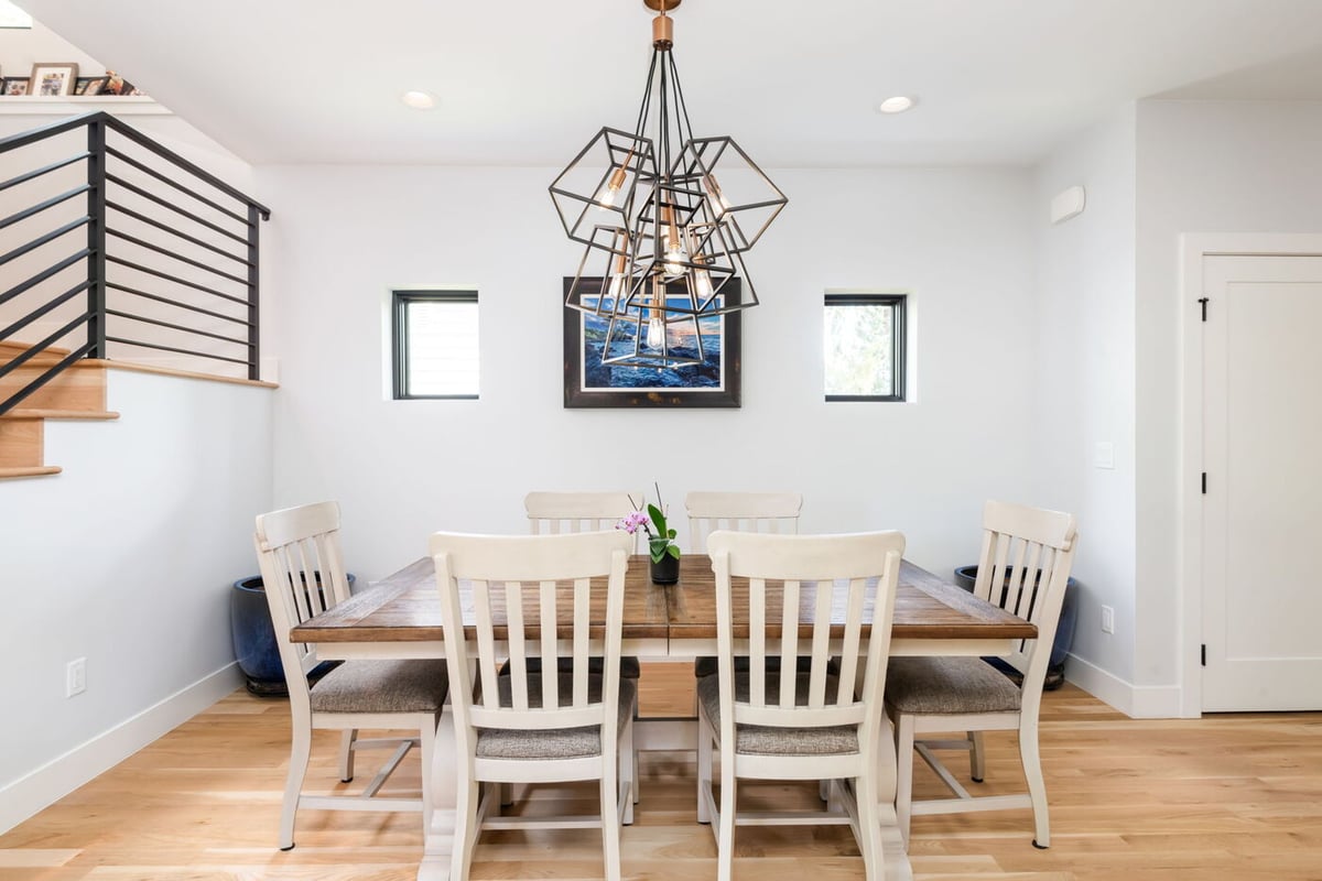Denver pop top renovation dining room with wood table, white chairs, and modern geometric chandelier by Cillessen Construction