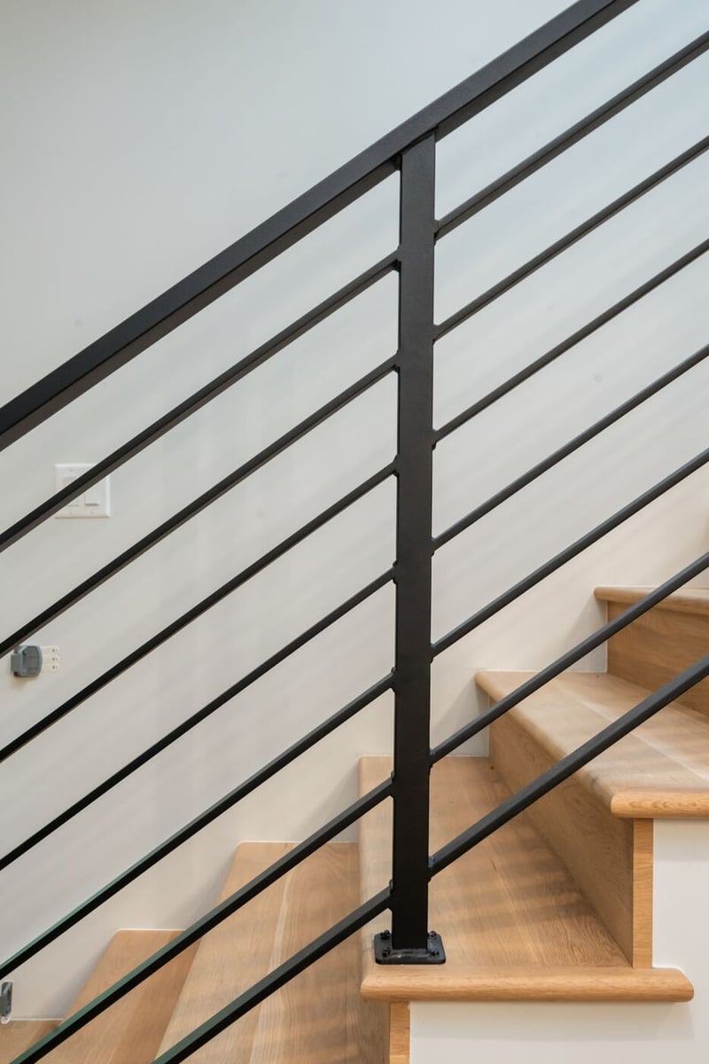 Modern Denver pop top renovation staircase with black metal railing and wood steps by Cillessen Construction