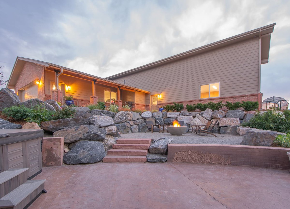 Backyard fire pit and covered patio next to garage build in Arvada, CO by Cillessen Construction