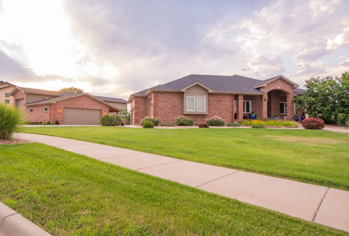 Front exterior with lawn and driveway next to garage build in Arvada, CO by Cillessen Construction