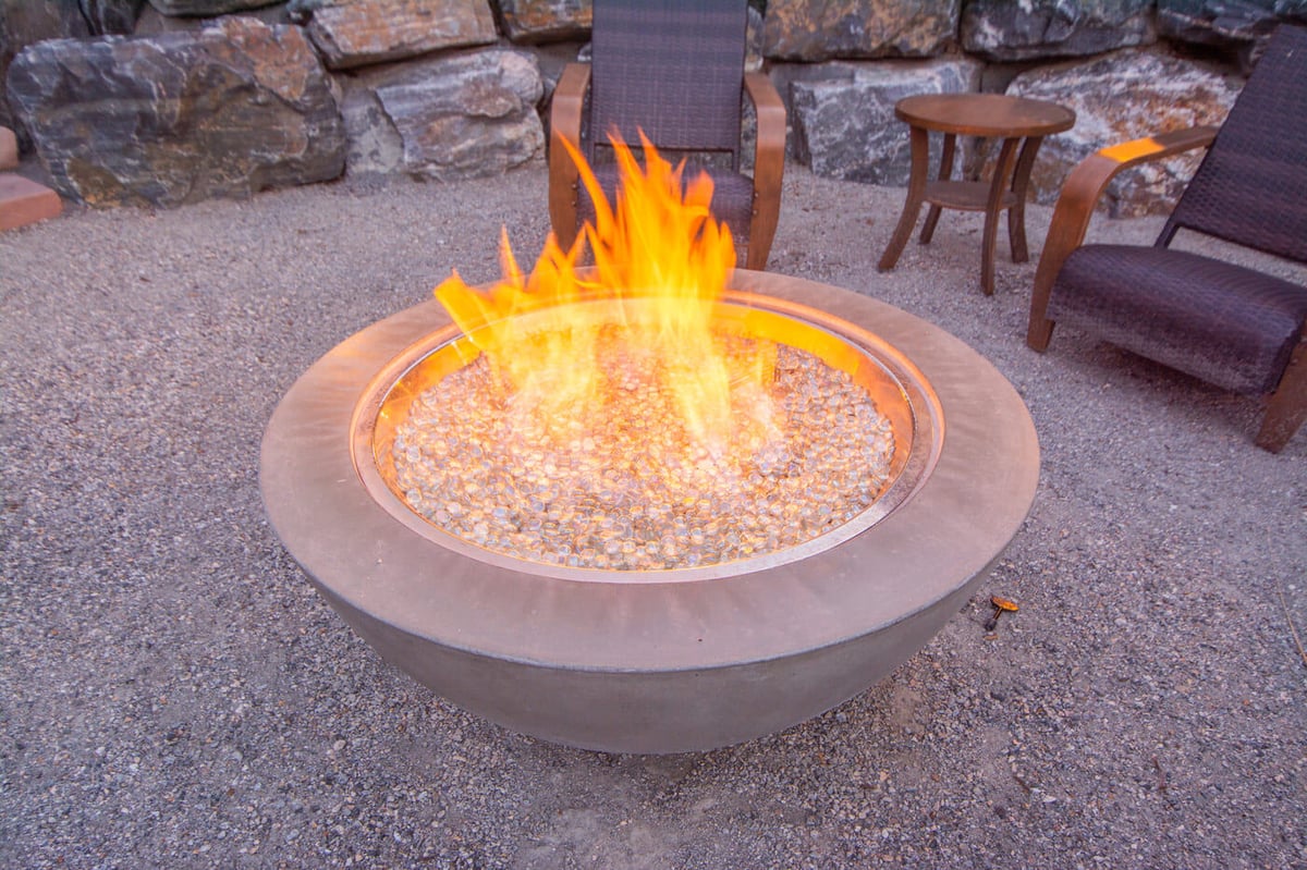 Modern fire pit with seating area in outdoor space of garage build in Arvada, CO by Cillessen Construction