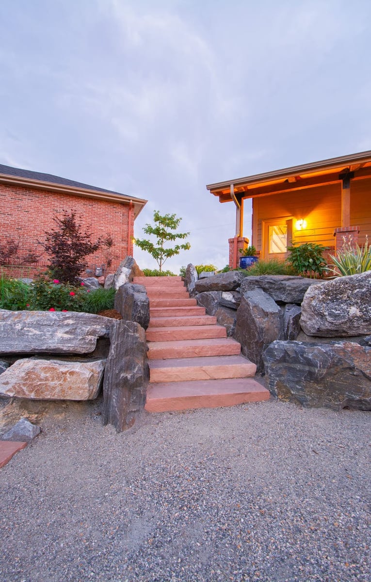 Stone steps and landscaped entry leading to garage build in Arvada, CO by Cillessen Construction