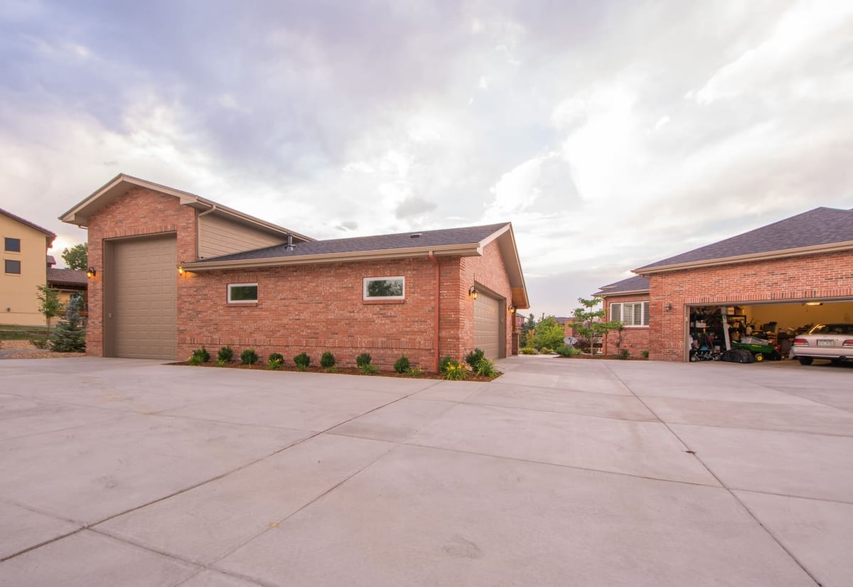 Wide driveway view with detached brick garage in Arvada, CO, built by Cillessen Construction