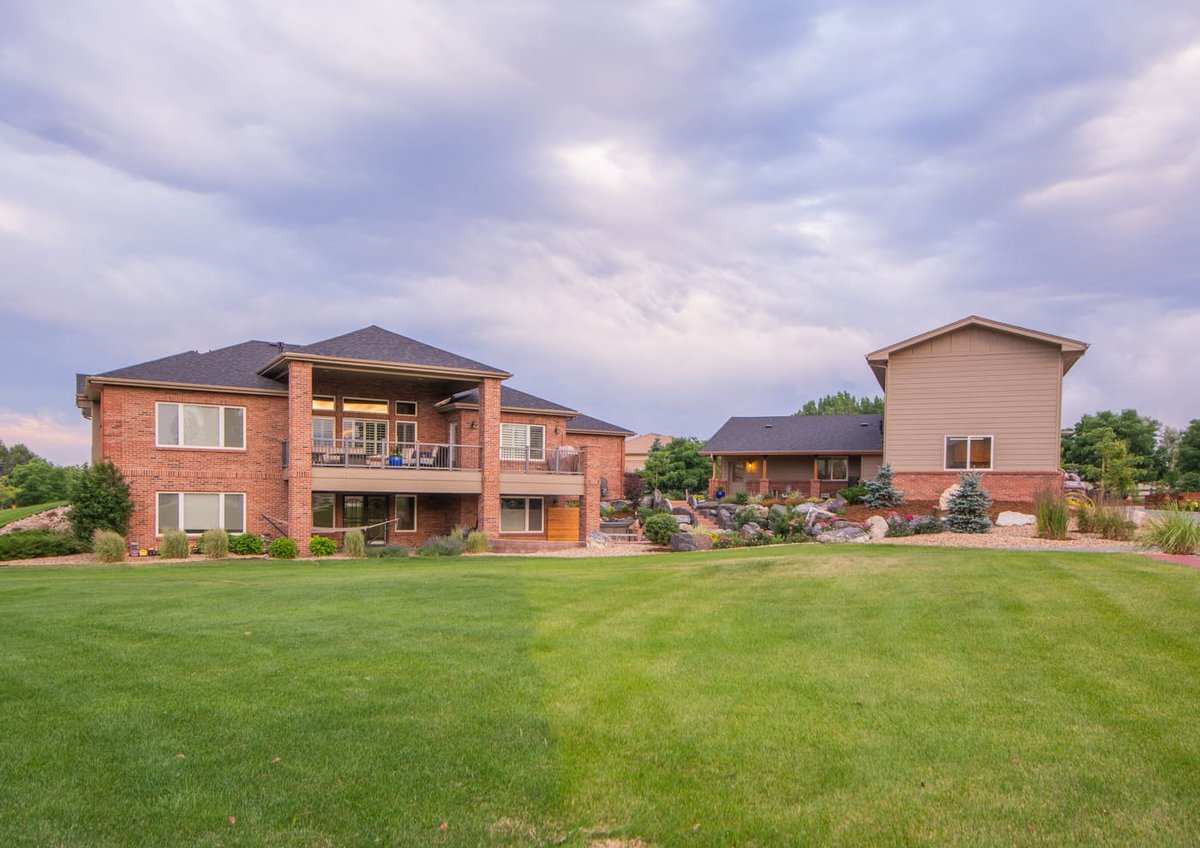 Wide view of home, yard, and detached garage build in Arvada, CO by Cillessen Construction