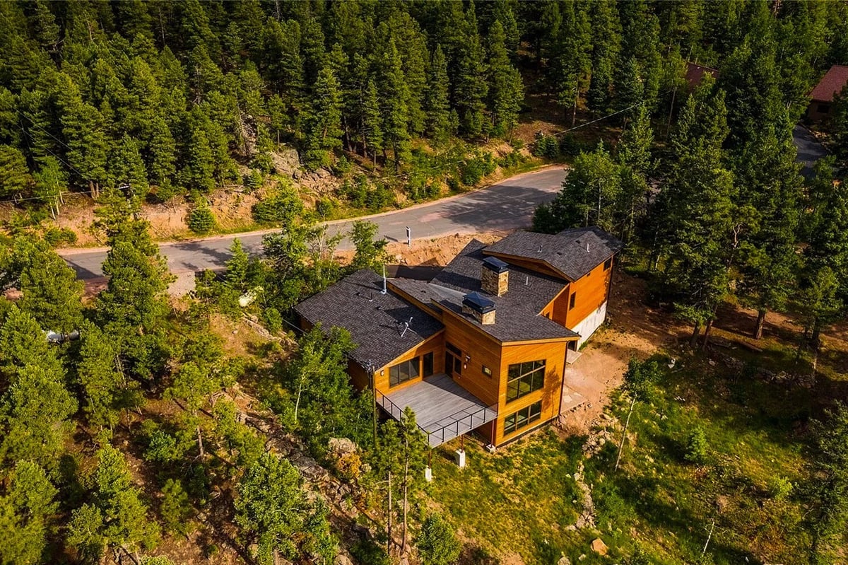denver-colorado-backyard-deck-by-cillessen-construction-company-with-wood-siding-large-windows-and-mountain-views