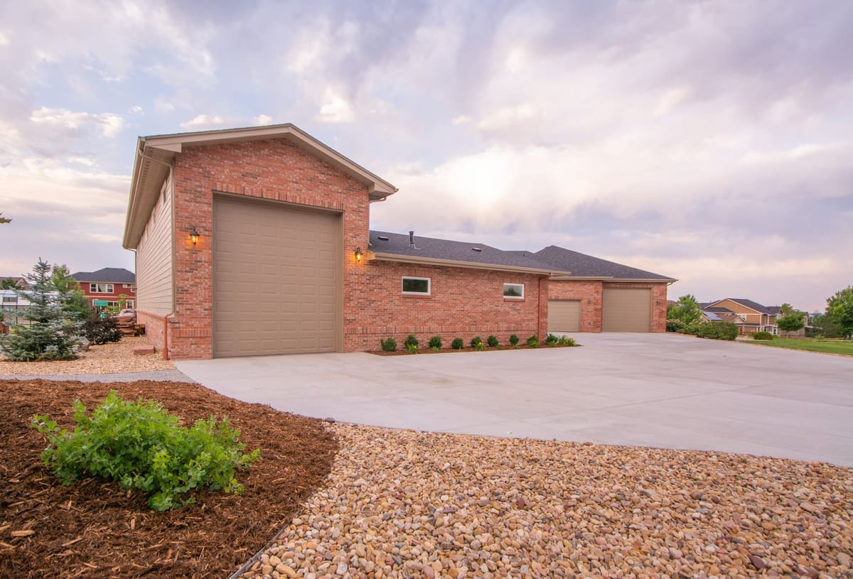 Brick garage with tall bay door and large driveway in Arvada, CO, built by Cillessen Construction