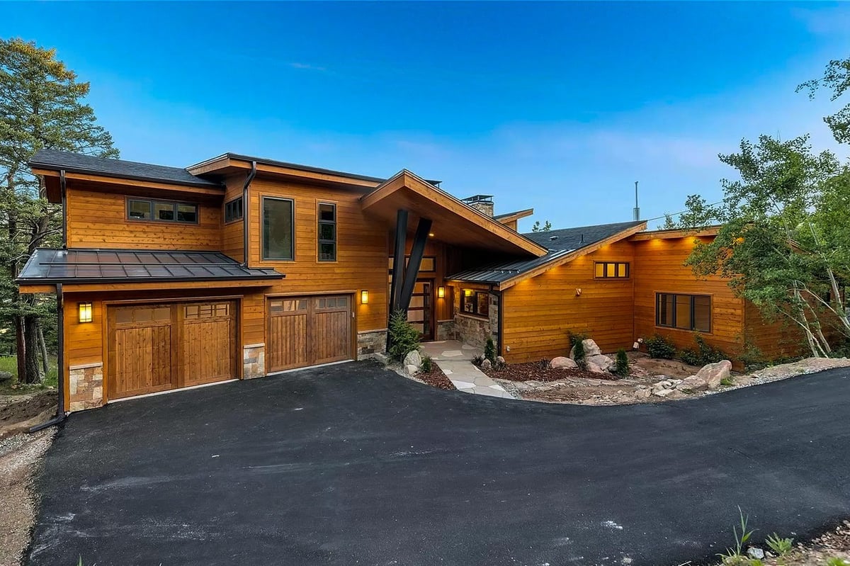 denver-colorado-modern-mountain-home-exterior-by-cillessen-construction-company-with-wood-siding-and-three-car-garage