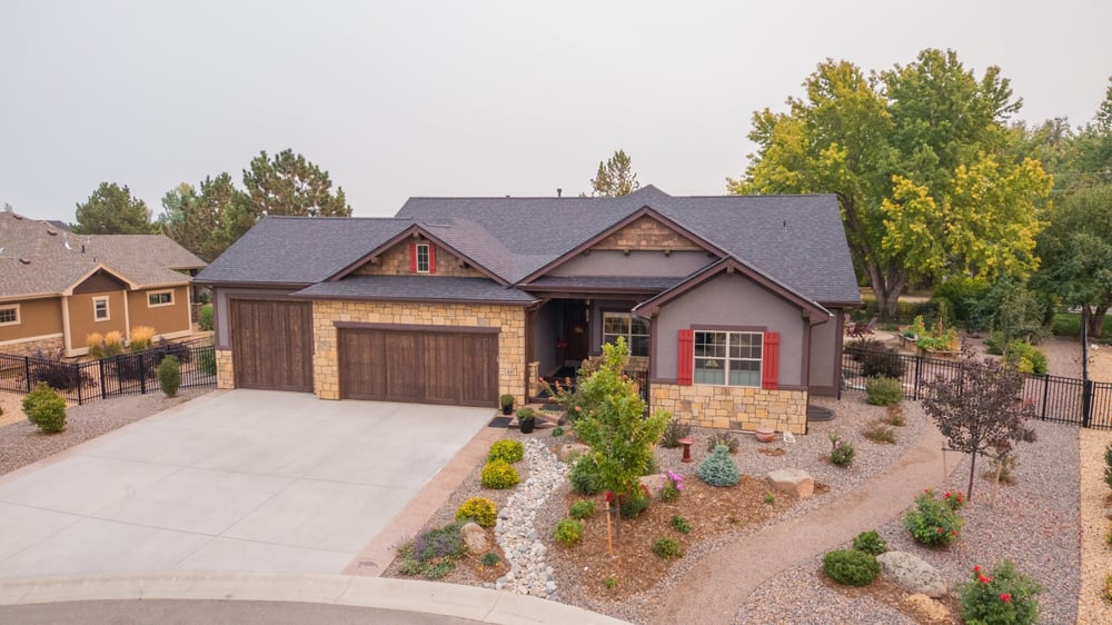 stone facade home exterior with driveway and curb appeal landscaping in denver colorado exterior renovation
