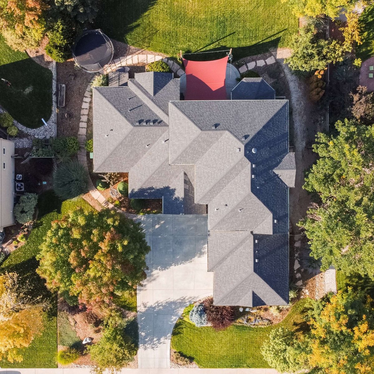 aerial view of large home roof exterior restoration in denver colorado with gray shingles and landscaped yard
