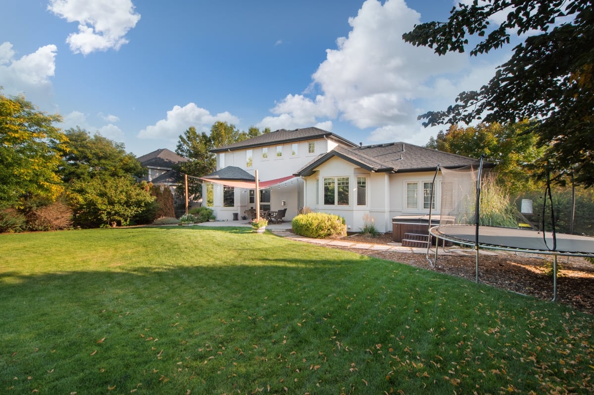 backyard view of home showing exterior restoration roofing in denver colorado with patio seating and shade canopy