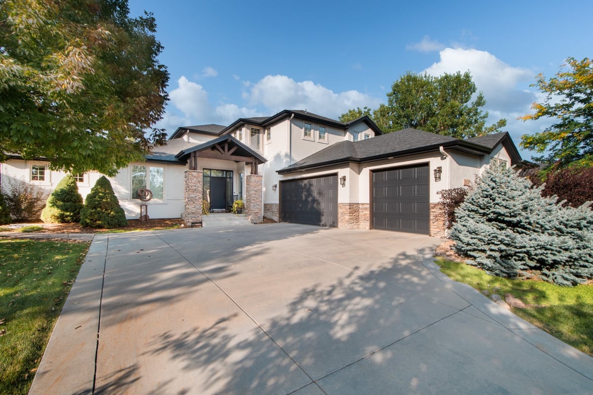 driveway and garage of home with exterior restoration roof installation in denver colorado featuring asphalt shingles
