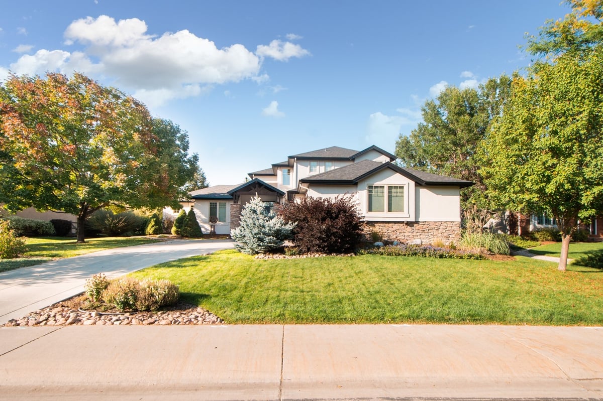 front exterior of modern home after exterior restoration in denver colorado with new roof and manicured lawn