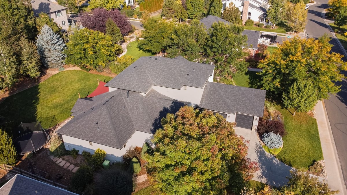 high angle drone view of residential exterior restoration roofing project in denver colorado showing backyard lawn and patio