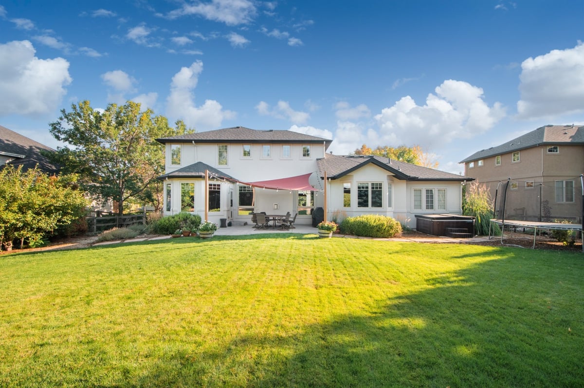 rear exterior of house with exterior restoration roofing project in denver colorado with lawn and outdoor space