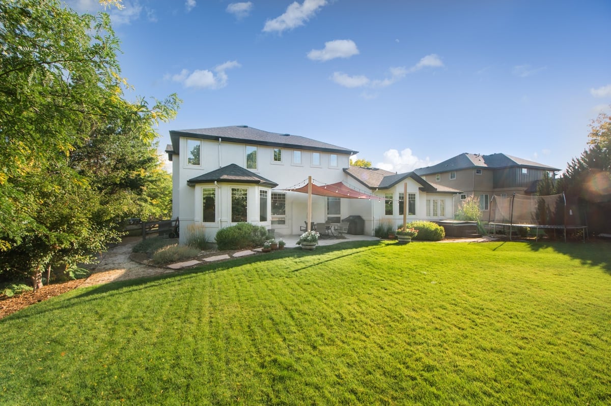 straight on backyard view of home with exterior restoration roof in denver colorado and covered patio area