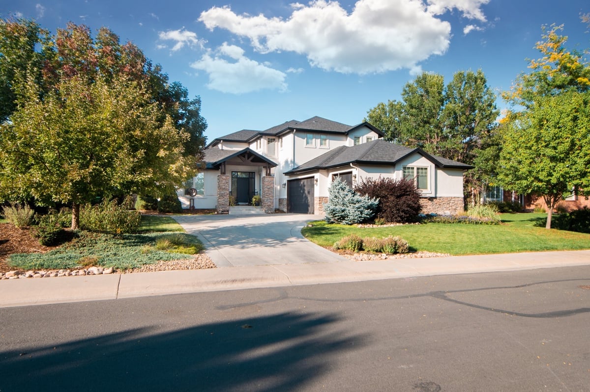 wide street view of house with completed exterior restoration roofing in denver colorado and clean landscaping
