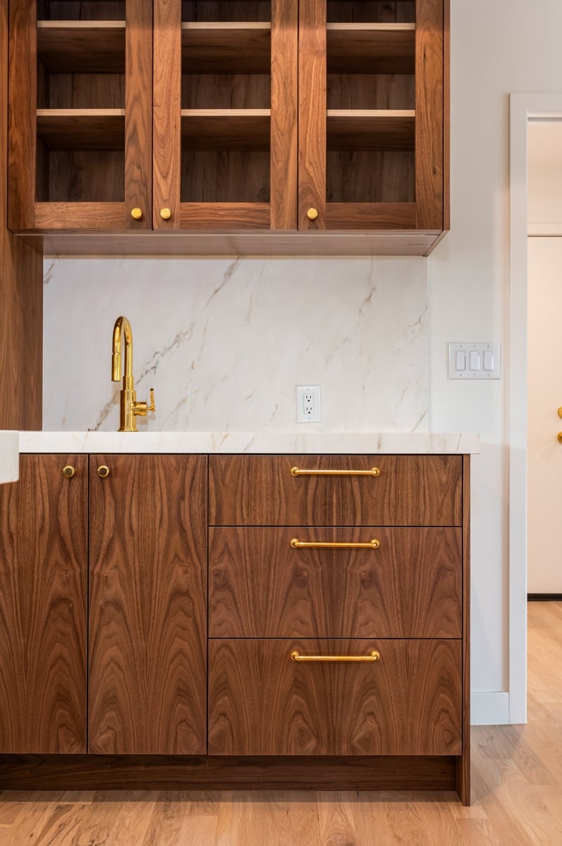 custom walnut bar cabinetry with brass fixtures in applewood village pop top renovation