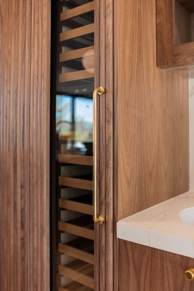 custom walnut wine storage cabinetry in applewood village pop top renovation