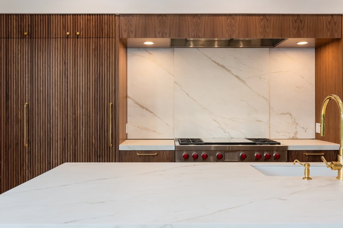luxury walnut kitchen with marble backsplash in applewood village pop top renovation