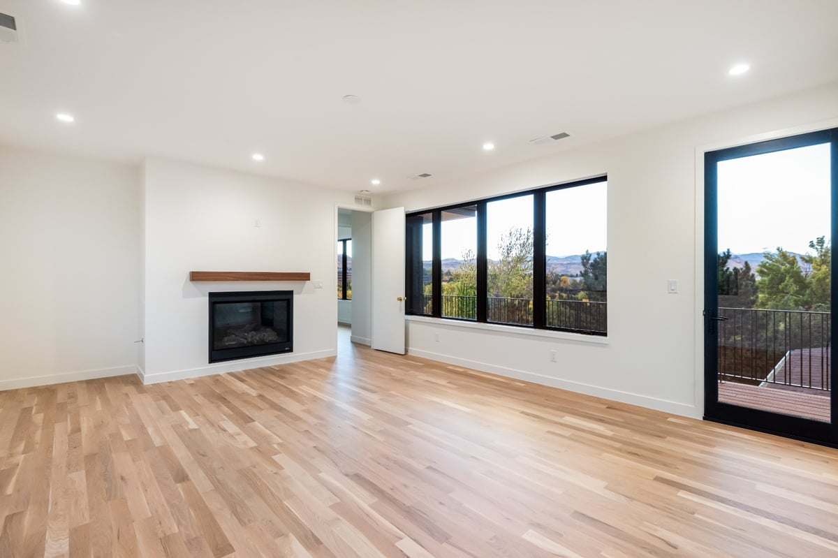 modern bedroom with fireplace and balcony in applewood village pop top renovation