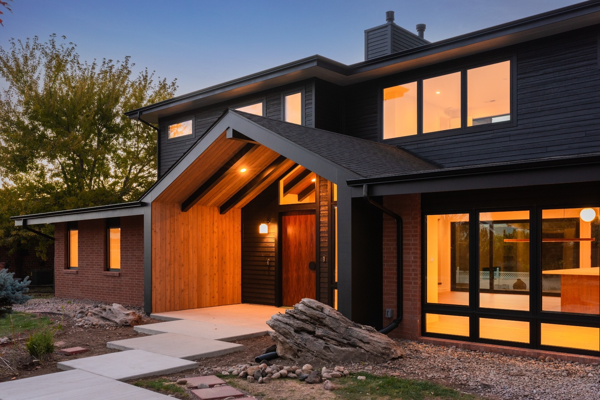 modern front exterior at dusk in applewood village pop top renovation