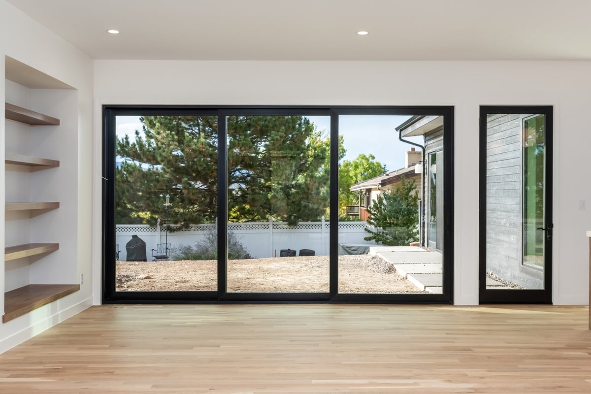 modern sliding glass doors and open living room in applewood village pop top renovation