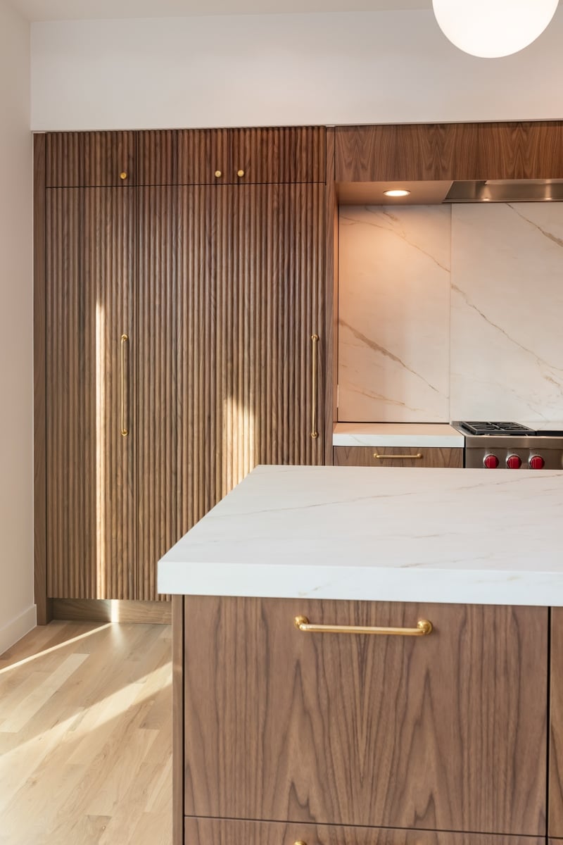 walnut kitchen island and custom cabinetry in applewood village pop top renovation