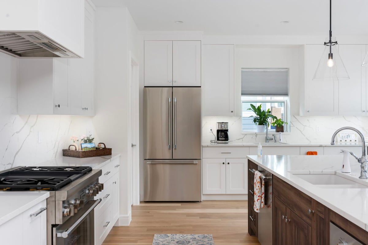 Louisville, CO custom home kitchen with stainless appliances and large island by Cillessen Construction