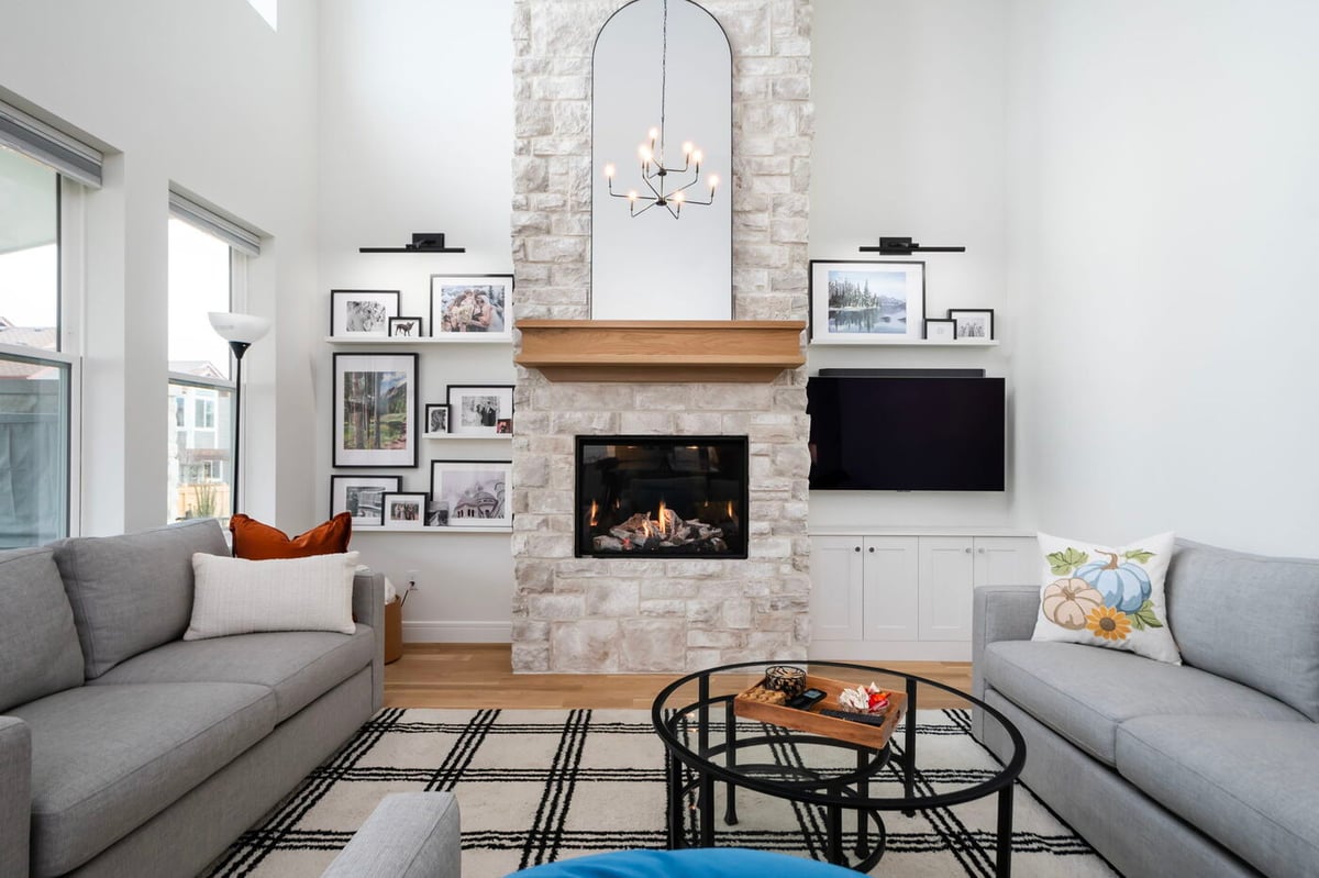 Louisville, CO custom home living room with tall ceilings, fireplace, and modern decor by Cillessen Construction