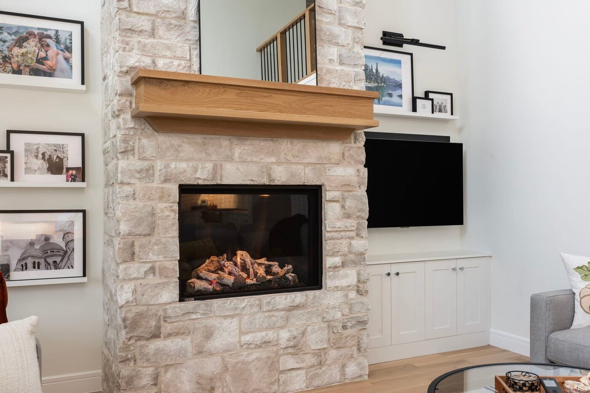 Louisville, CO custom home stone fireplace with wood mantel and built-ins by Cillessen Construction
