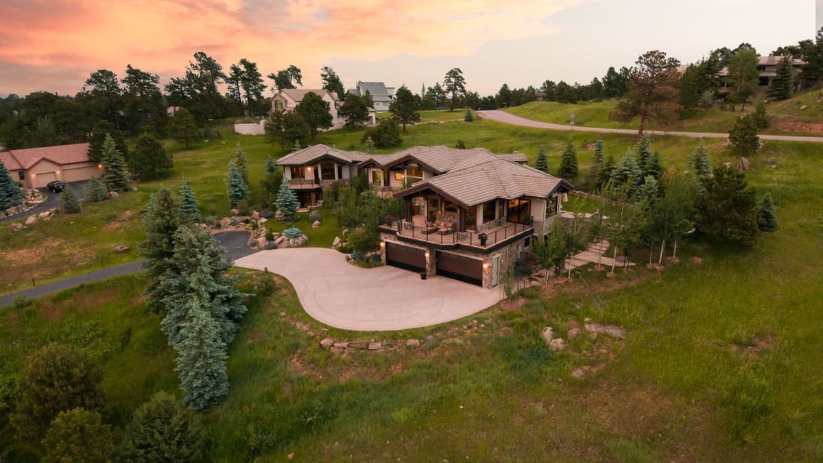 Genesee, CO renovation aerial of home on hillside with driveway and landscaping by Cillessen Construction