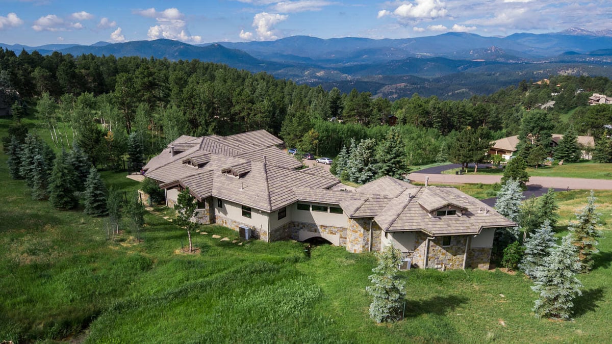 Genesee, CO renovation aerial of home with mountain views and wooded landscape by Cillessen Construction
