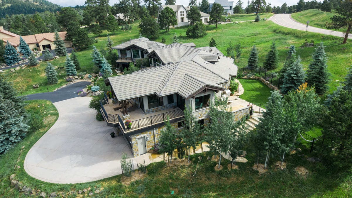 Genesee, CO renovation aerial of multi-level home with expansive yard and patio by Cillessen Construction