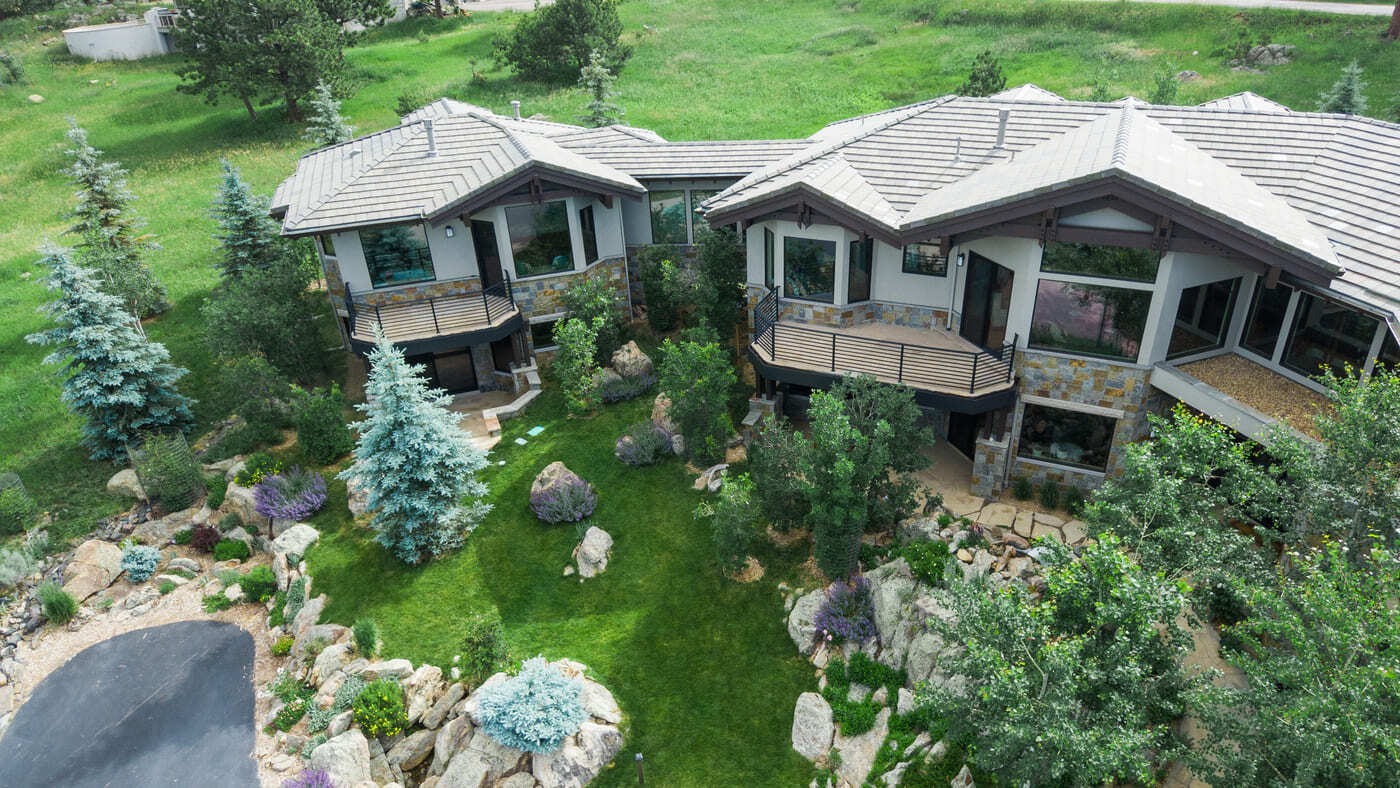 Genesee, CO renovation aerial showing backyard landscaping, stonework, and terraces by Cillessen Construction