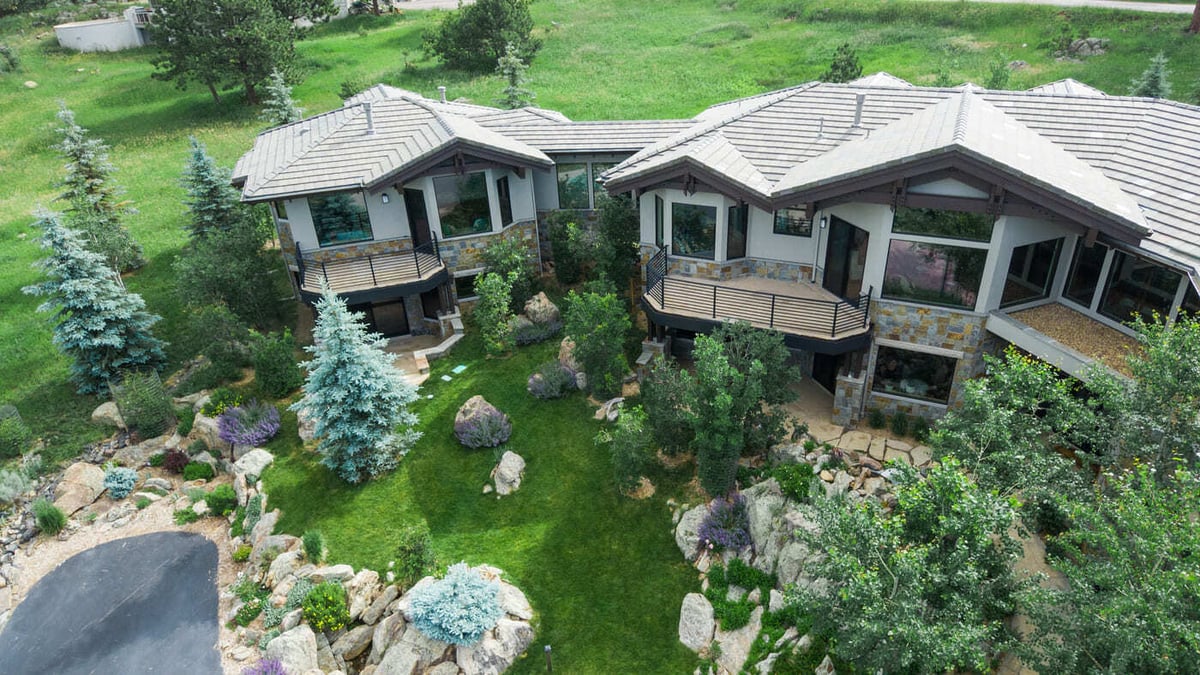 Genesee, CO renovation aerial showing backyard landscaping, stonework, and terraces by Cillessen Construction