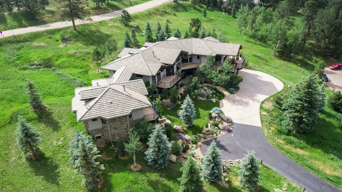 Genesee, CO renovation aerial showing curved driveway and surrounding greenery by Cillessen Construction
