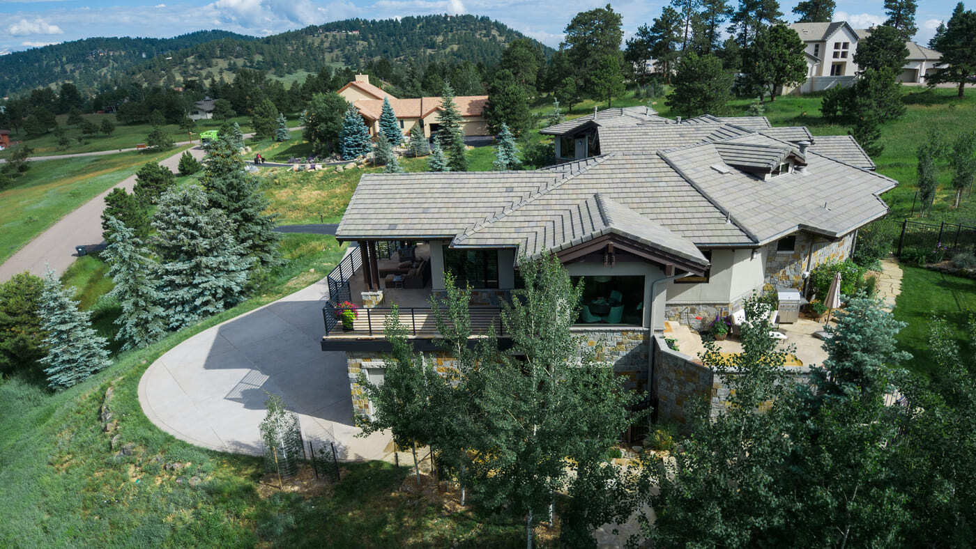 Genesee, CO renovation aerial showing deck, patio, and landscaped hillside by Cillessen Construction
