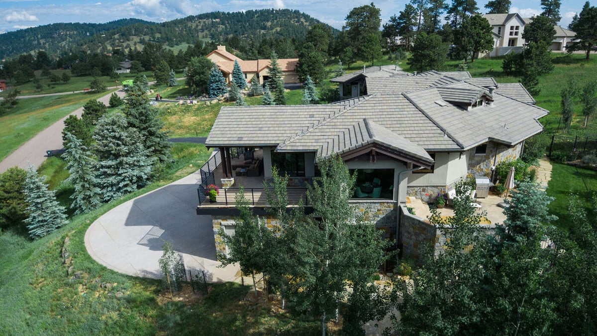 Genesee, CO renovation aerial showing deck, patio, and landscaped hillside by Cillessen Construction