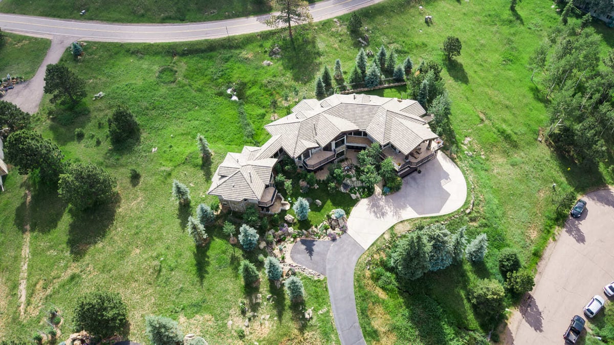 Genesee, CO renovation aerial showing home, driveway, and surrounding greenery by Cillessen Construction