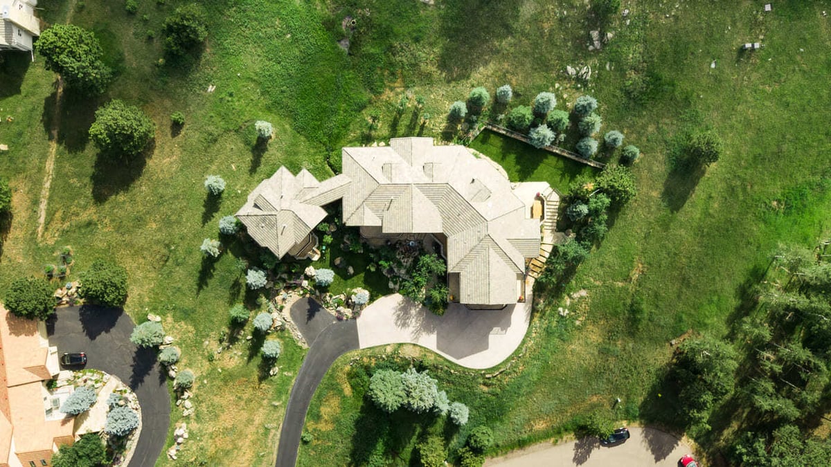 Genesee, CO renovation aerial top view with landscaped yard and curved driveway by Cillessen Construction