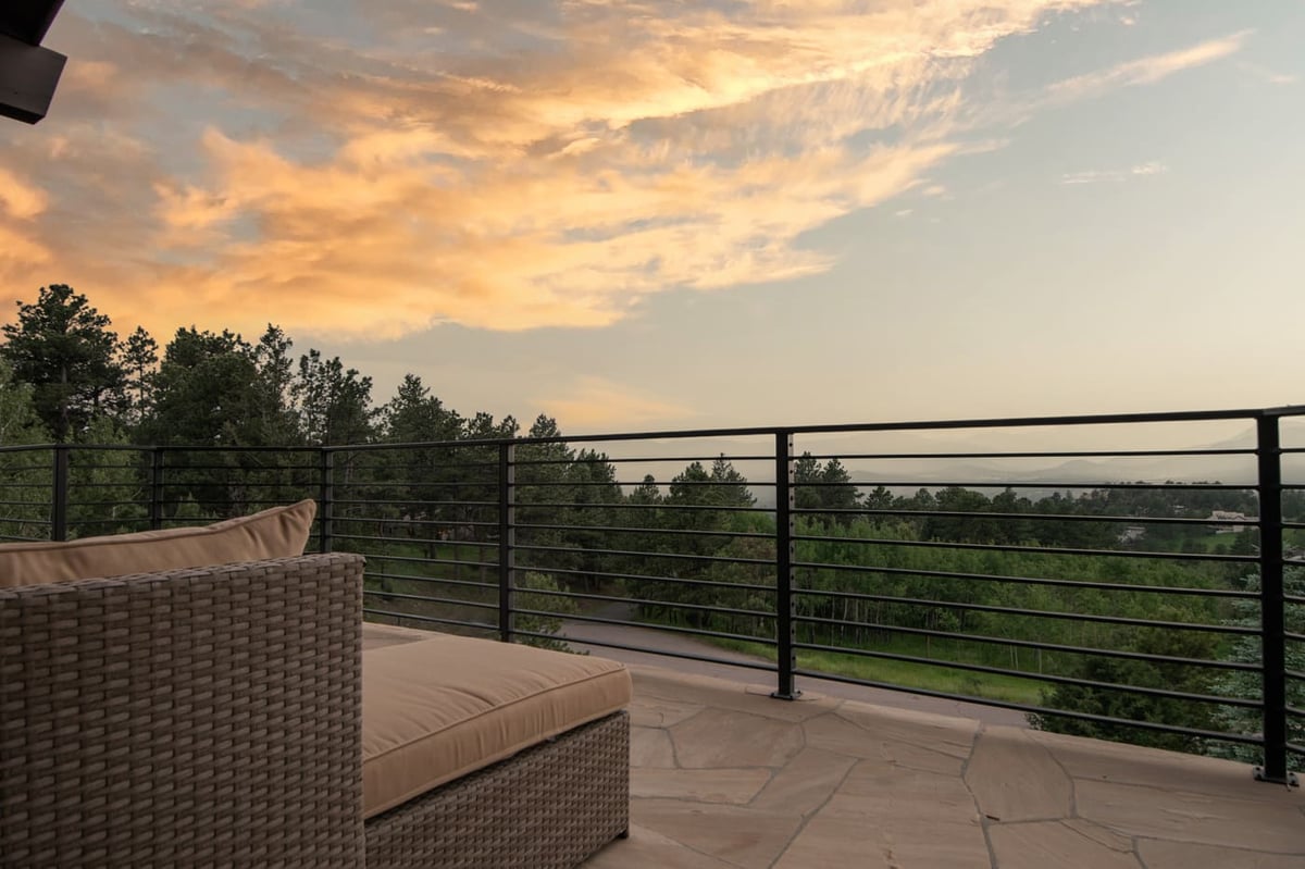 Genesee, CO renovation deck seating with railing and sunset mountain views by Cillessen Construction