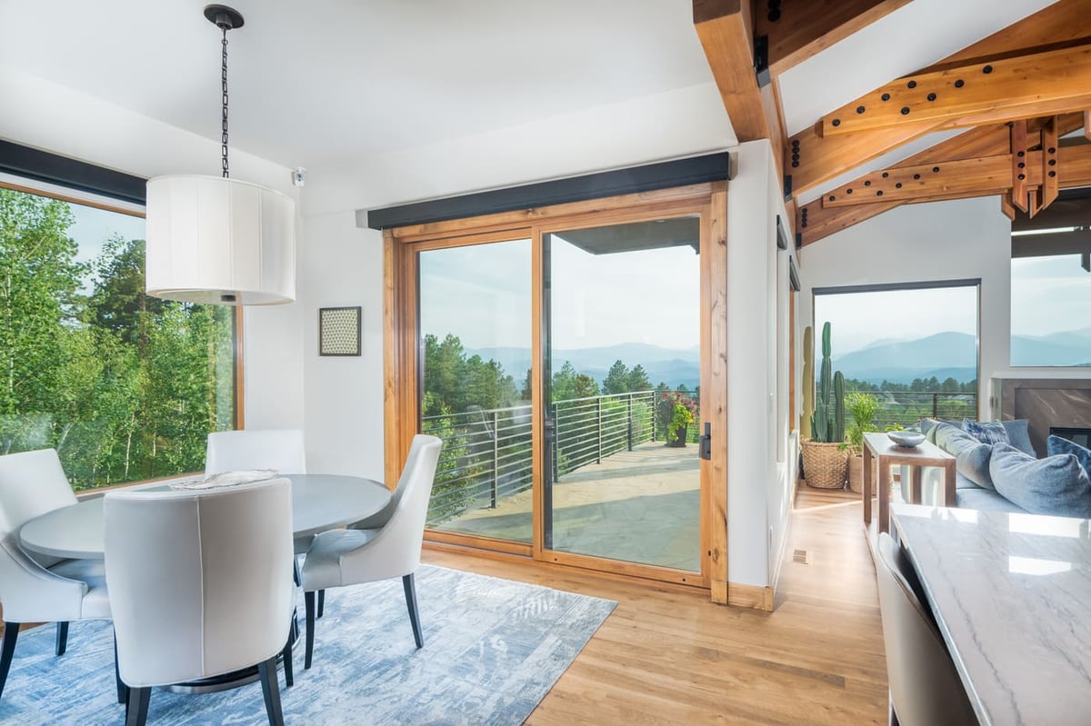 Genesee, CO renovation dining area with sliding doors and mountain views by Cillessen Construction