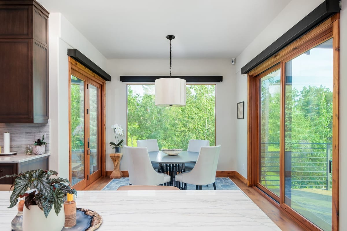 Genesee, CO renovation dining nook with large windows and deck access by Cillessen Construction