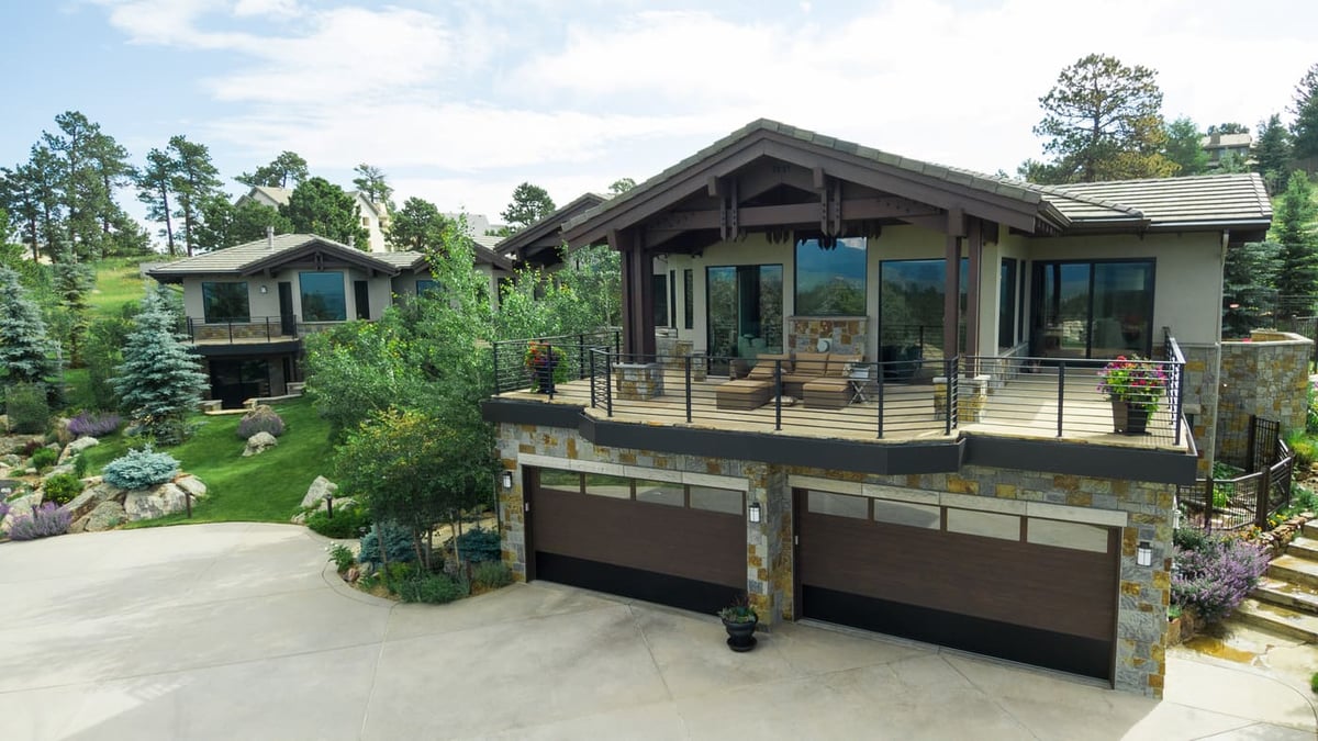 Genesee, CO renovation exterior with deck, garage, and landscaped yard by Cillessen Construction