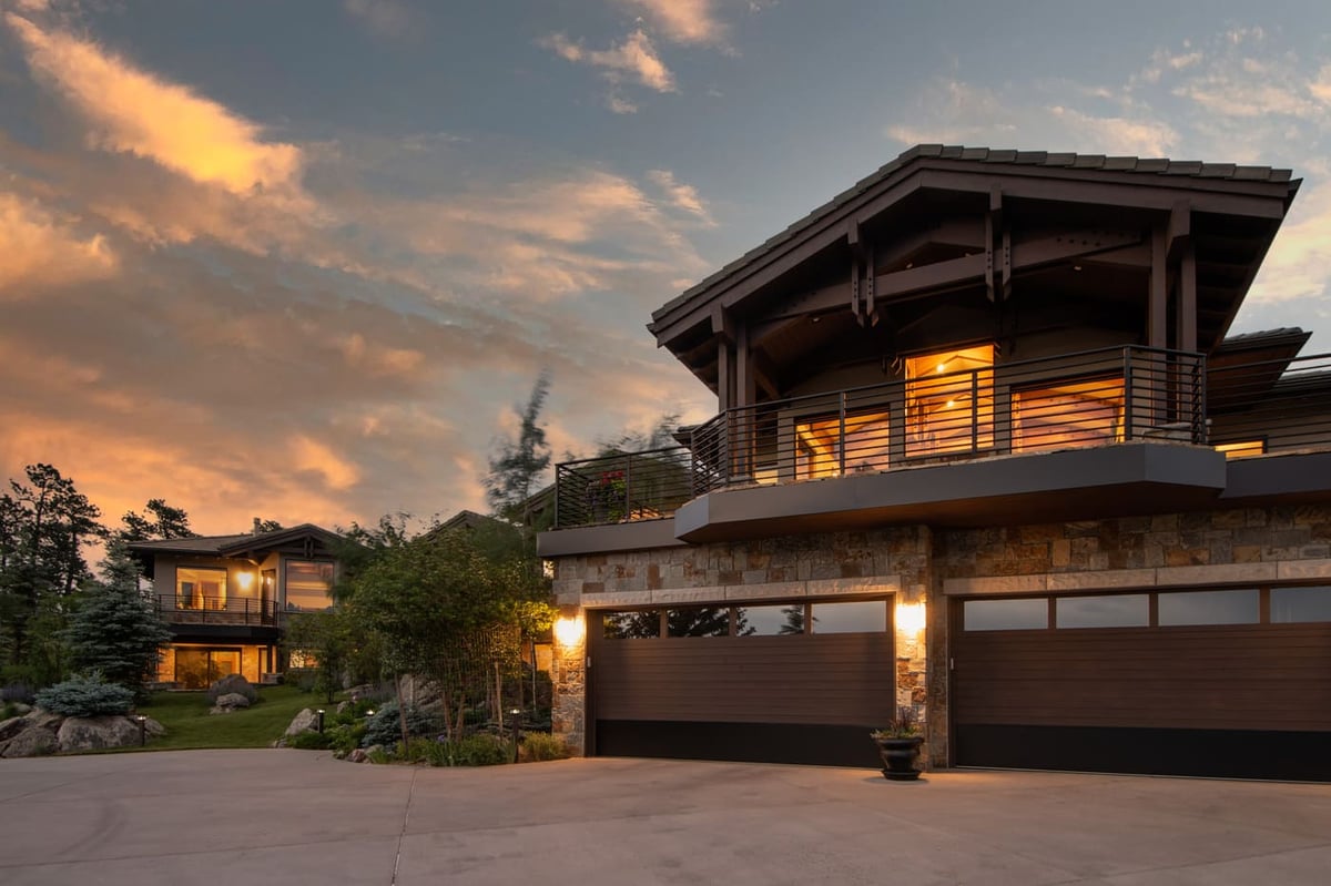 Genesee, CO renovation exterior with modern mountain home and evening lighting by Cillessen Construction