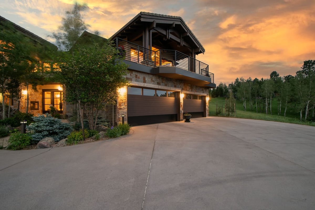Genesee, CO renovation exterior with stone facade, garage, and sunset views by Cillessen Construction