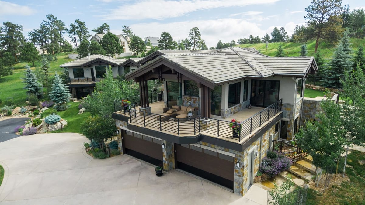 Genesee, CO renovation exterior with wraparound deck and mountain views by Cillessen Construction