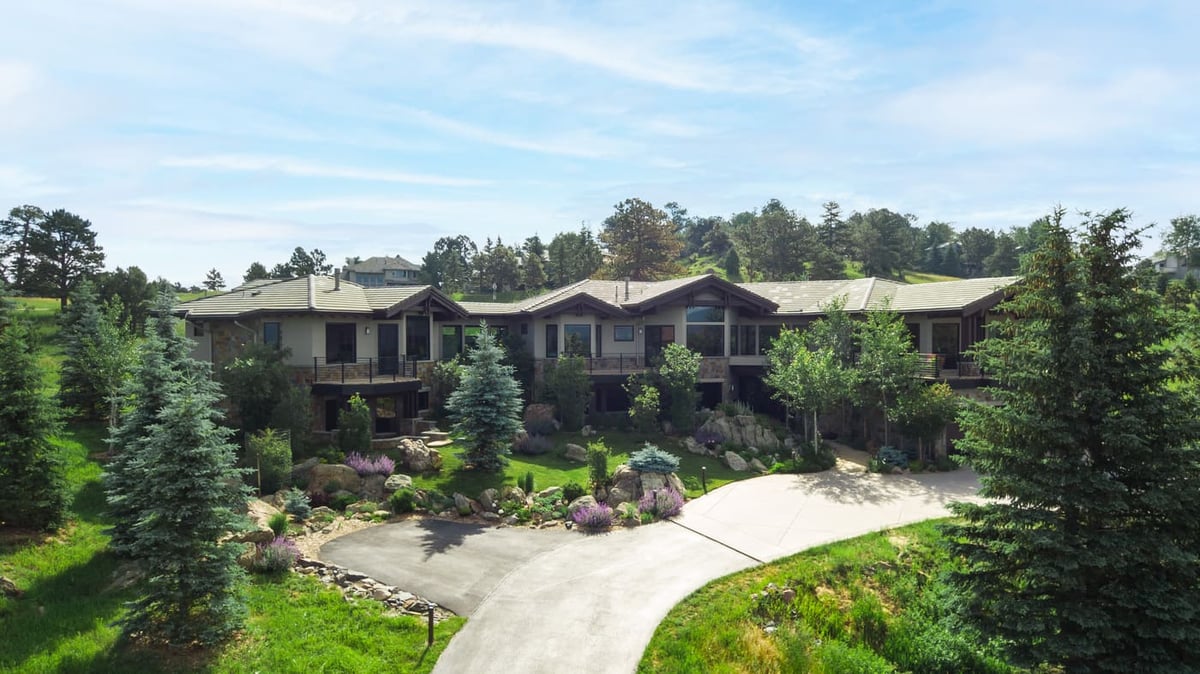 Genesee, CO renovation front exterior with curved driveway and landscaped yard by Cillessen Construction