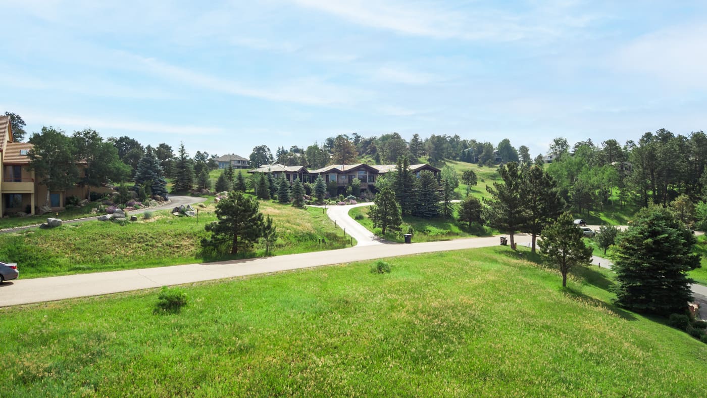 Genesee, CO renovation neighborhood view with winding road and surrounding greenery by Cillessen Construction